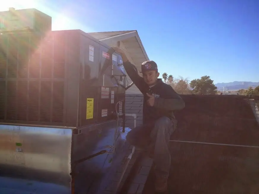 HVAC technician performing AC Tune-Up on a rooftop unit in Upper Uwchlan
